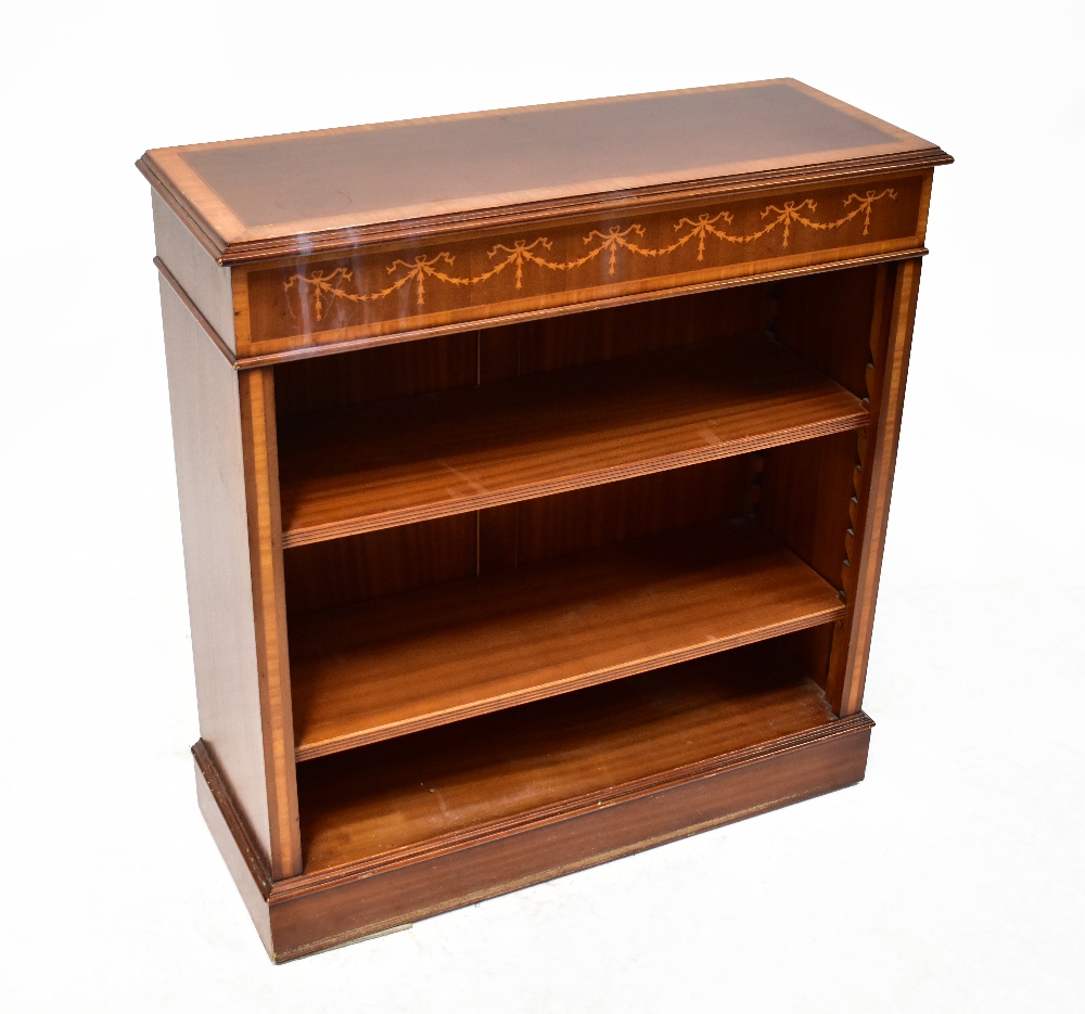 An Edwardian-style inlaid mahogany floor standing bookshelf with inlaid tulip wood swag design