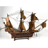 A late 19th/early 20th century wooden model of the Golden Hind with rigging and parchment effect