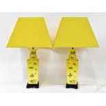 A pair of 20th century Chinese lamps in the form of yellow ground square-sided vases with tapered