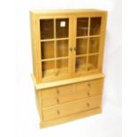 A modern carpenter made clothes cabinet, with six glazed panels to the doors,