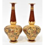 DOULTON LAMBETH; a pair of late 19th century stoneware vases of onion shape, with flared rim,