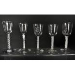 Five 18th century opaque air twist stem wine glasses, each with tapering bowls and simple feet,