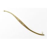 A 9ct gold three-colour bracelet with an elongated oval centre,