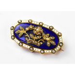 An early 19th century gilt and enamel oval brooch,