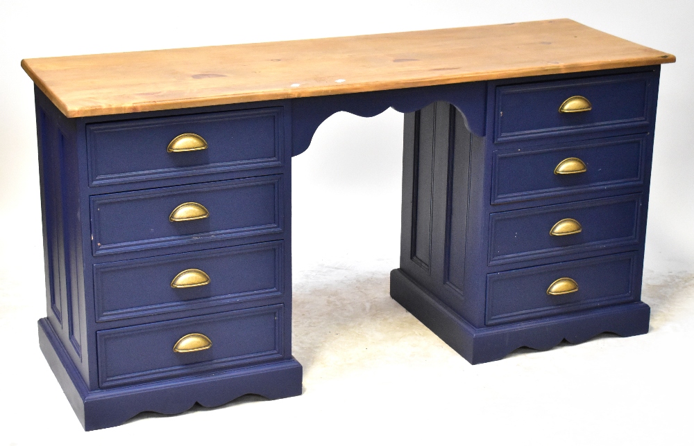 A twin pedestal desk with varnished top and painted blue base, each pedestal with four drawers,