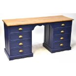 A twin pedestal desk with varnished top and painted blue base, each pedestal with four drawers,