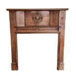 An early 20th century Arts & Crafts style oak fire surround,