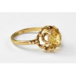 A 9ct gold dress ring with floral set yellow faceted stone, with graduated gold bead shoulders,