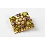A vintage 9ct gold multicoloured gem set brooch, the 9ct gold floral frame in a diamond shape,