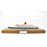 A replica model of 'Queen Elizabeth II', dated 1993, in a Perspex display case,