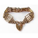 A late 19th/early 20th century rose gold five bar gate bracelet, with 9ct rose gold padlock clasp,