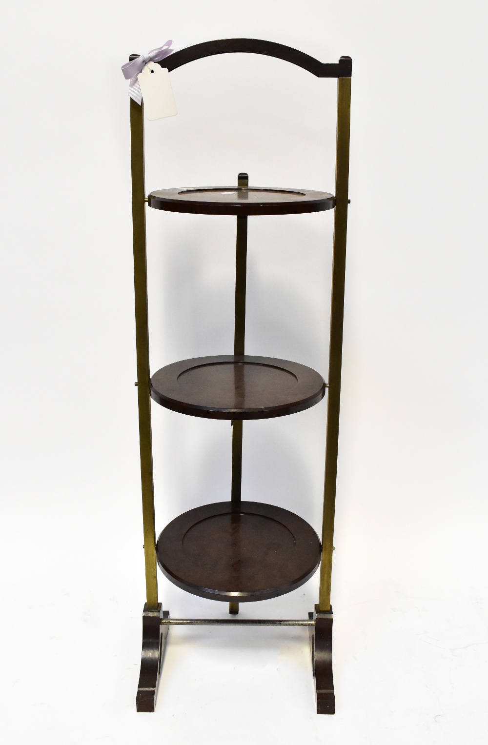 A mid-20th century mahogany-effect Bakelite and brass folding three-tier cake stand, height 91cm.