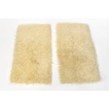 Two sheepskin rungs with woven backs, each approx 120 x 62cm (2).