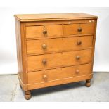 An early 20th century pine chest of two short over three long drawers, raised on turned supports,