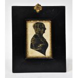 A 19th century black and gilt-highlighted silhouette portrait of a lady,