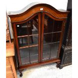 An early 20th century mahogany dome-topped display cabinet,