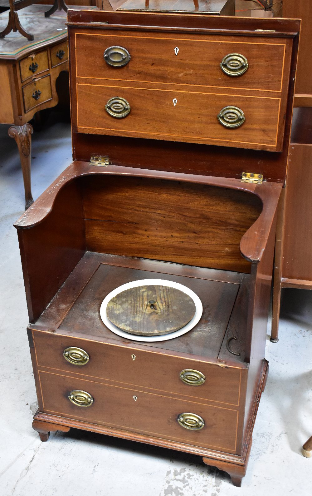 A 19th century mahogany line inlaid commode in the form of a four-drawer bachelor's chest,