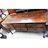 A George III oak dresser base, the plank top above six short drawers,