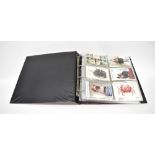 A folder containing various colour and black and white postcards,