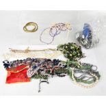 A large quantity of costume jewellery to include various necklaces, some with semiprecious stones,