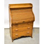 An early 20th century oak roll-top desk of diminutive proportions,