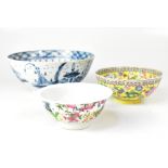 A group of three Oriental ceramics, a blue and white bowl with village and scenic views,