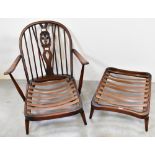 ERCOL; a dark stained low stick-back open-arm lounge chair,
