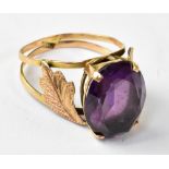 A vintage Egyptian yellow gold dress ring, with large marquise-shaped claw set purple stone,