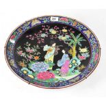 A late 19th early/20th century Oriental charger in the Famille Rose palette,