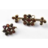 An early 19th century garnet cluster brooch in a 9ct gold setting (lacking one stone),
