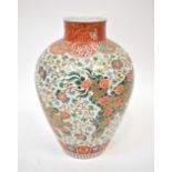 A large 19th century Chinese Wucai baluster vase painted with two lion dogs amidst large
