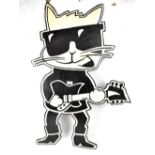 A novelty cut-out of a cat playing a guitar,