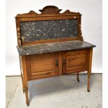 An Edwardian walnut marble-top wash stand,