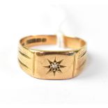 A 9ct rose gold gentleman's signet ring with single starburst diamond to platform top, size Q,