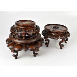Three late 19th/early 20th century mahogany vase stands of various designs, shapes and sizes,