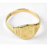 A gentlemen's 9ct gold signet ring, with shield table, partially engraved but worn,