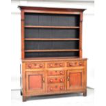 A 19th century mahogany dresser with moulded cornice above boarded plate rack of three shelves,