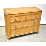 A Victorian pine chest of three short over two long drawers, with moulded glass handles,