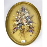 A late 20th century shell picture depicting a bunch of garden flowers in shells of different colour,