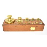 A set of thirteen brass weights, the largest being 1kg, with multiple proof marks,