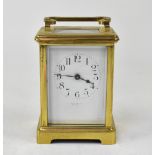 A French brass carriage clock, the enamelled dial set with Arabic numerals,