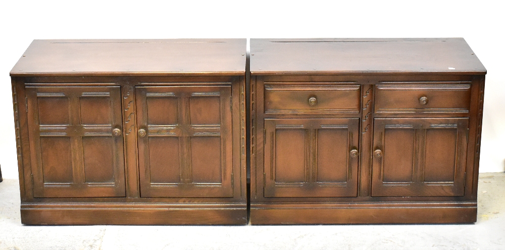 ERCOL; two dark dresser bases, one with a pair of fielded and panelled cupboard doors,