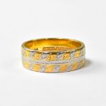 A 22ct white and yellow gold chased wedding band, size N, approx 7.3g.