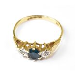 A 9ct gold dress ring, with central claw set blue stone, possibly topaz,