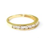 A modern 9ct gold half eternity ring with a row of pavé set cubic zirconia stones,