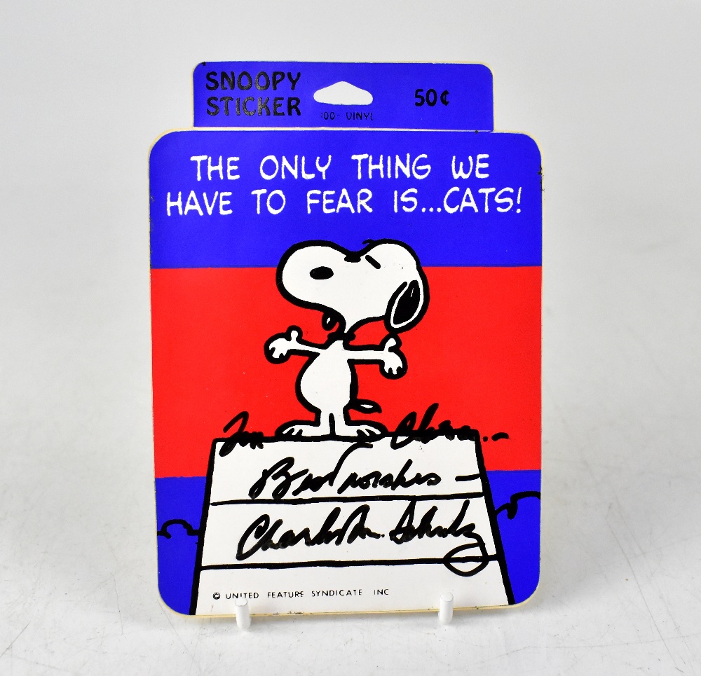 SNOOPY; a sticker bearing the signature of Charles Schulz both front and back,