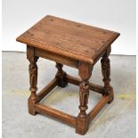 An oak joint stool with rectangular top, on bulbous carved and turned supports united by stretchers,