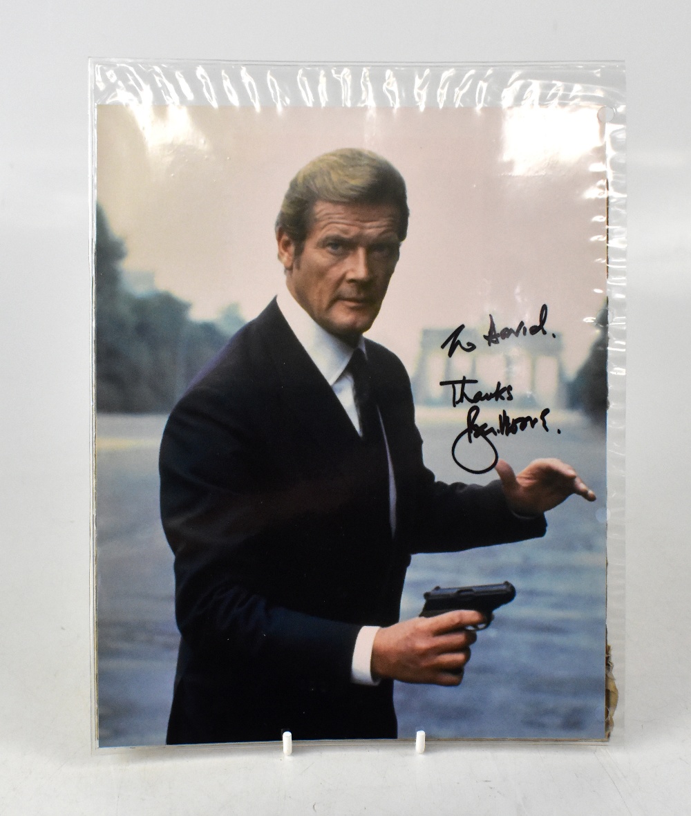 ROGER MOORE; a coloured photograph bearing the James Bond actor's signature, 25 x 20cm, unframed.