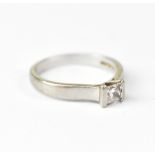 A bespoke made platinum solitaire ring with central tension set princess cut diamond,