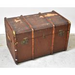 A large early 20th century canvas travel trunk with wood and brass laths, initialled to side,
